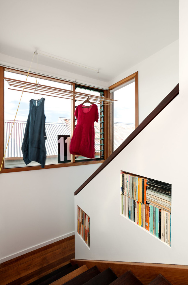 Photo of a mid-sized contemporary wood u-shaped staircase in Melbourne with wood risers and wood railing.