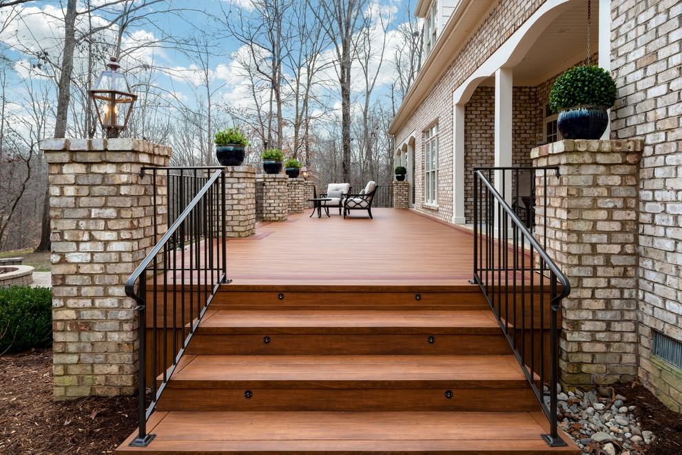 Large transitional backyard deck photo with a fire pit and no cover