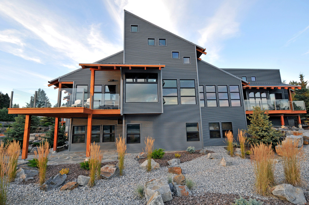 Inspiration for a large contemporary two-storey grey house exterior in Vancouver with metal siding.