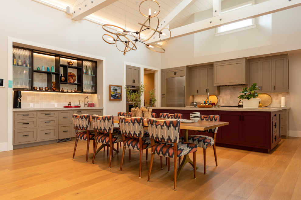 Inspiration for an expansive country galley open plan kitchen in San Francisco with light hardwood floors, yellow floor, exposed beam, an undermount sink, recessed-panel cabinets, red cabinets, quartzite benchtops, white splashback, ceramic splashback, stainless steel appliances, with island and white benchtop.