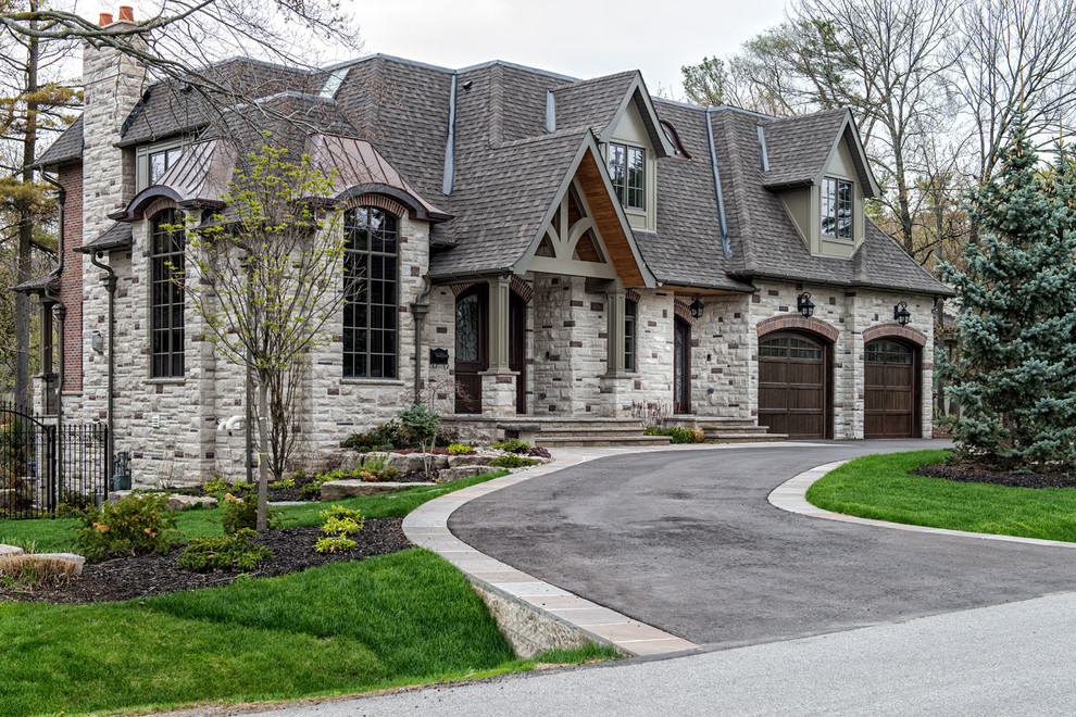Inspiration for a large transitional gray two-story stone flat roof remodel in Toronto
