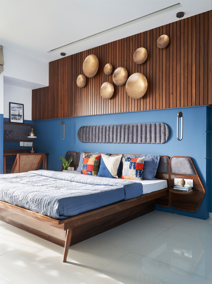 Modelo de dormitorio actual con paredes azules y suelo gris