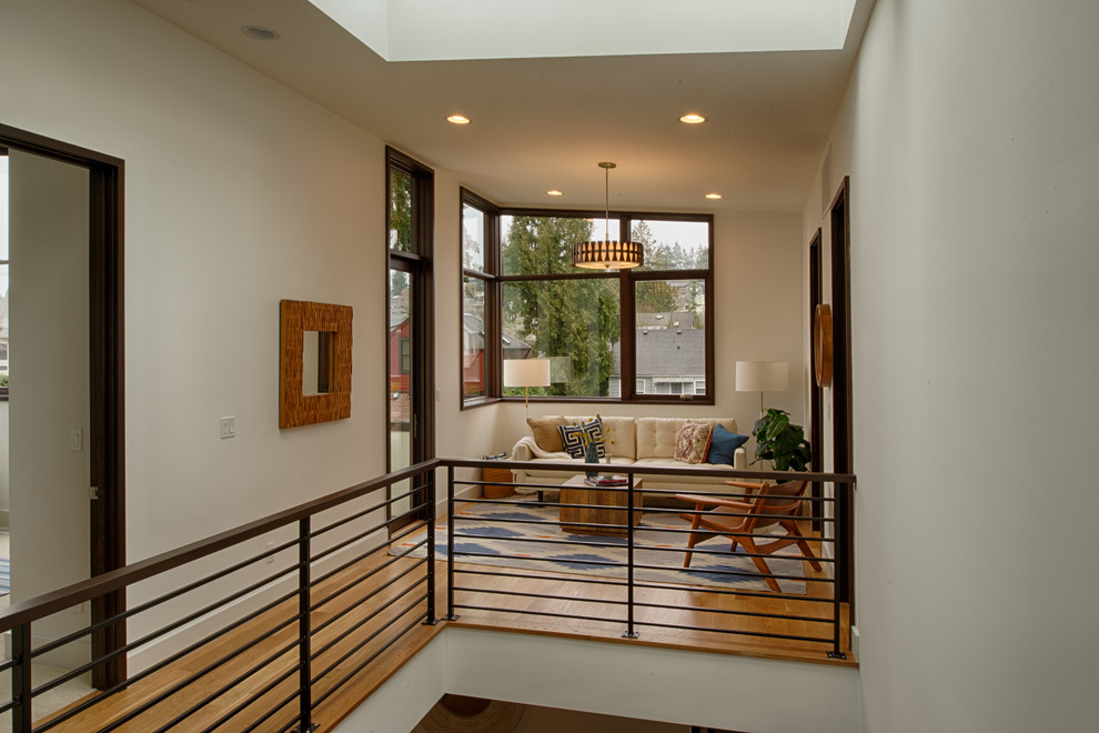 Photo of a mid-sized contemporary family room in Seattle with beige walls, medium hardwood floors and orange floor.