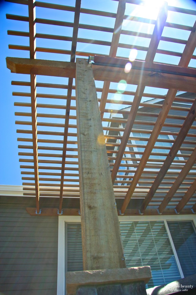 Deck - mid-sized rustic backyard deck idea in Denver with a pergola