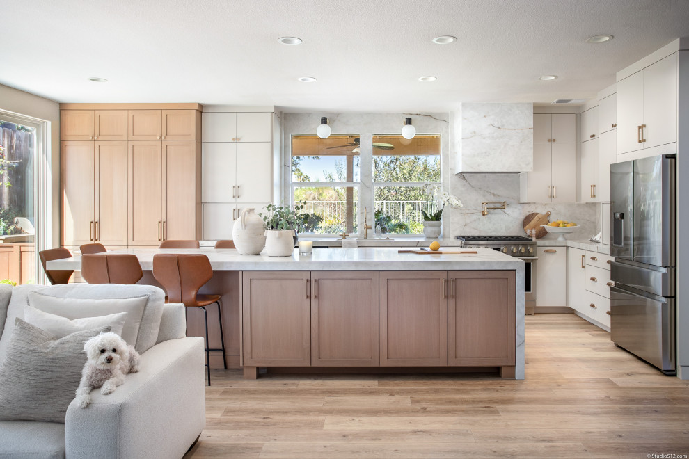 Inspiration for a mid-sized transitional vinyl floor and brown floor eat-in kitchen remodel in San Diego with an undermount sink, stainless steel appliances and an island
