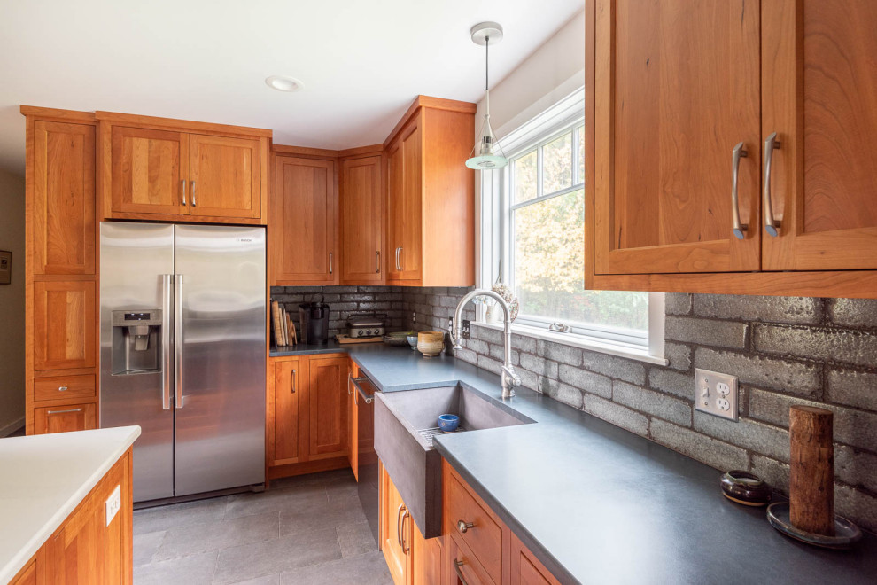 Inspiration for a large transitional l-shaped porcelain tile and gray floor eat-in kitchen remodel in Boston with a farmhouse sink, shaker cabinets, medium tone wood cabinets, quartz countertops, gray backsplash, porcelain backsplash, stainless steel appliances, an island and white countertops