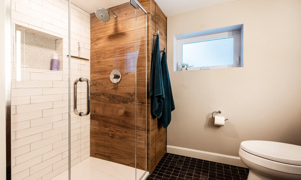 Mid-sized modern kids bathroom in Chicago with flat-panel cabinets, dark wood cabinets, an alcove shower, a one-piece toilet, yellow tile, porcelain tile, grey walls, porcelain floors, an integrated sink, solid surface benchtops, black floor, a hinged shower door and white benchtops.