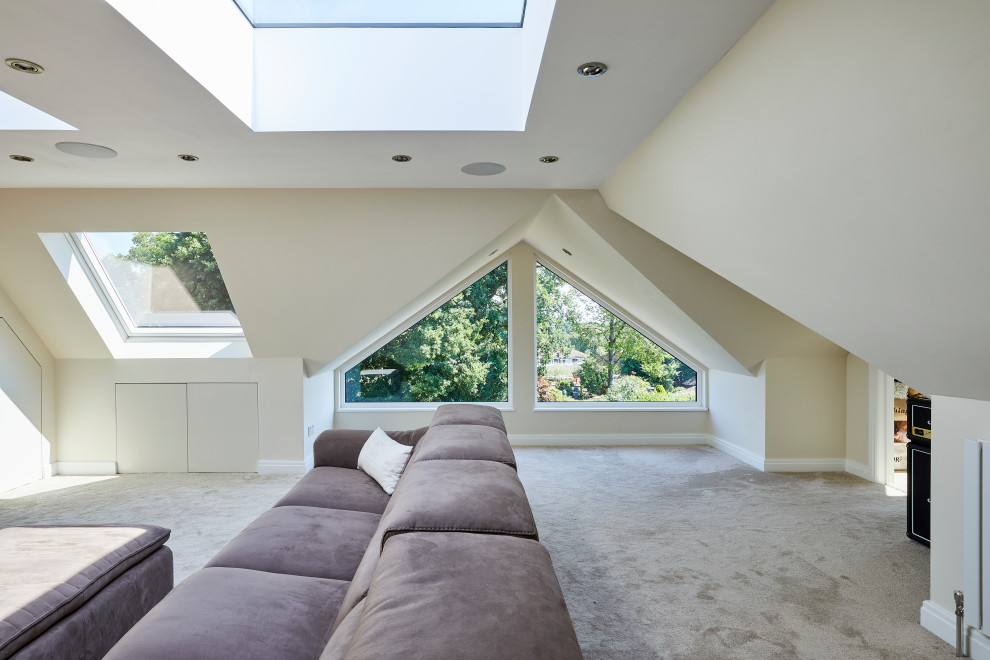Photo of a mid-sized modern open concept family room in London with white walls, carpet, grey floor and vaulted.