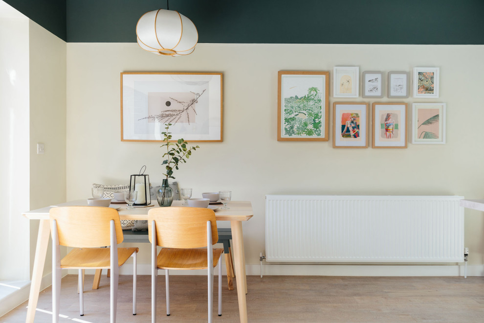 This is an example of a medium sized scandi dining room in Dorset.