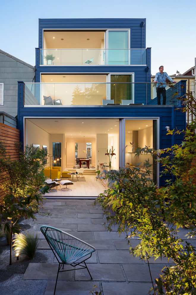 Design ideas for a mid-sized contemporary three-storey blue house exterior in San Francisco with wood siding, a flat roof and a mixed roof.