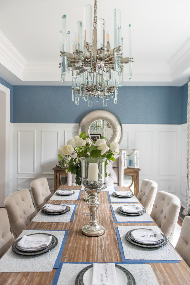 Large transitional medium tone wood floor and brown floor enclosed dining room photo in Toronto with blue walls and no fireplace