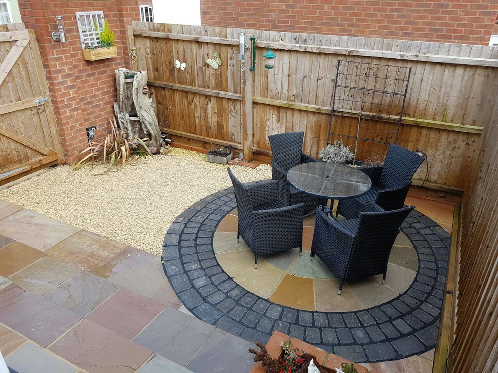 Photo of a small modern backyard patio in Other with natural stone pavers and no cover.