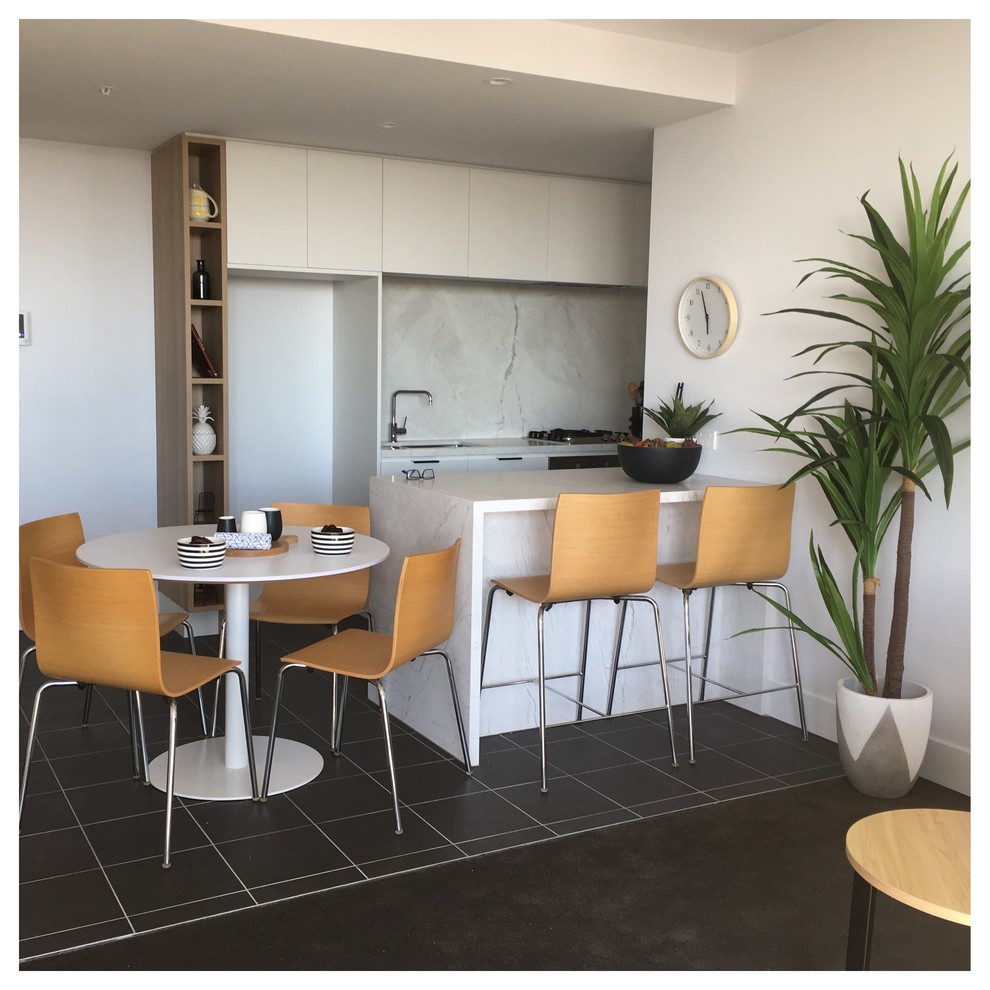 Design ideas for a small scandinavian galley eat-in kitchen in Melbourne with an undermount sink, flat-panel cabinets, white cabinets, marble benchtops, grey splashback, stone slab splashback, stainless steel appliances, porcelain floors and a peninsula.