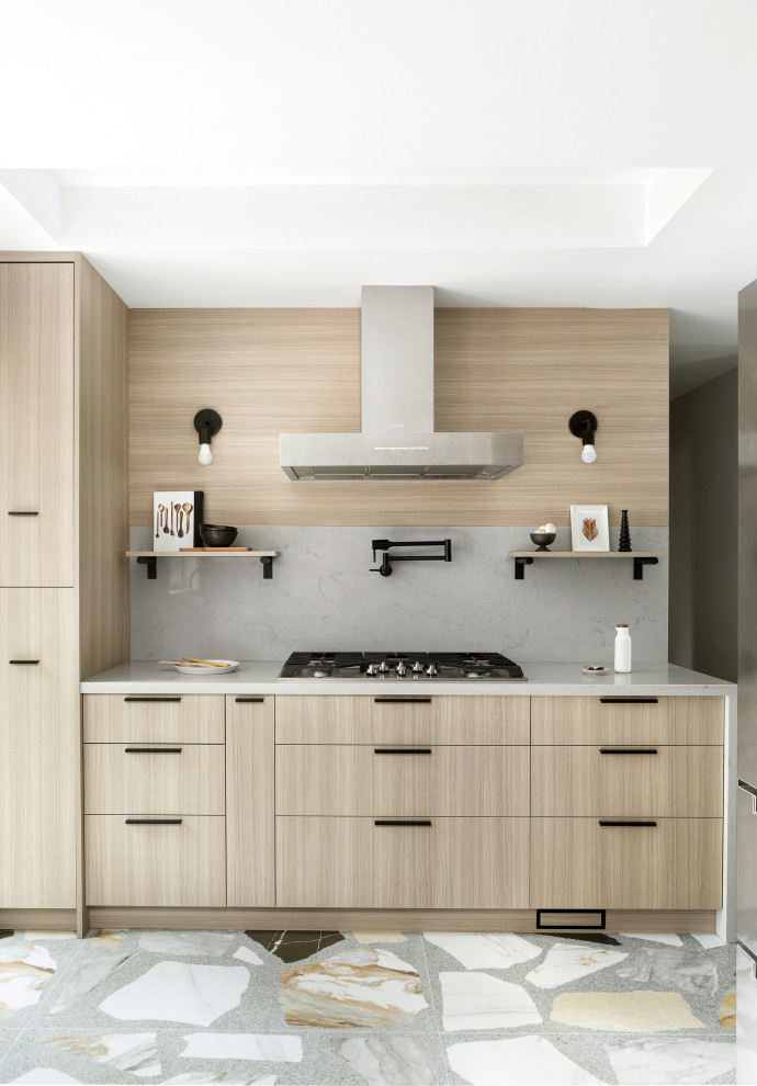 Small contemporary u-shaped kitchen in Toronto with a submerged sink, flat-panel cabinets, light wood cabinets, engineered stone countertops, grey splashback, engineered quartz splashback, stainless steel appliances, porcelain flooring, multi-coloured floors and grey worktops.