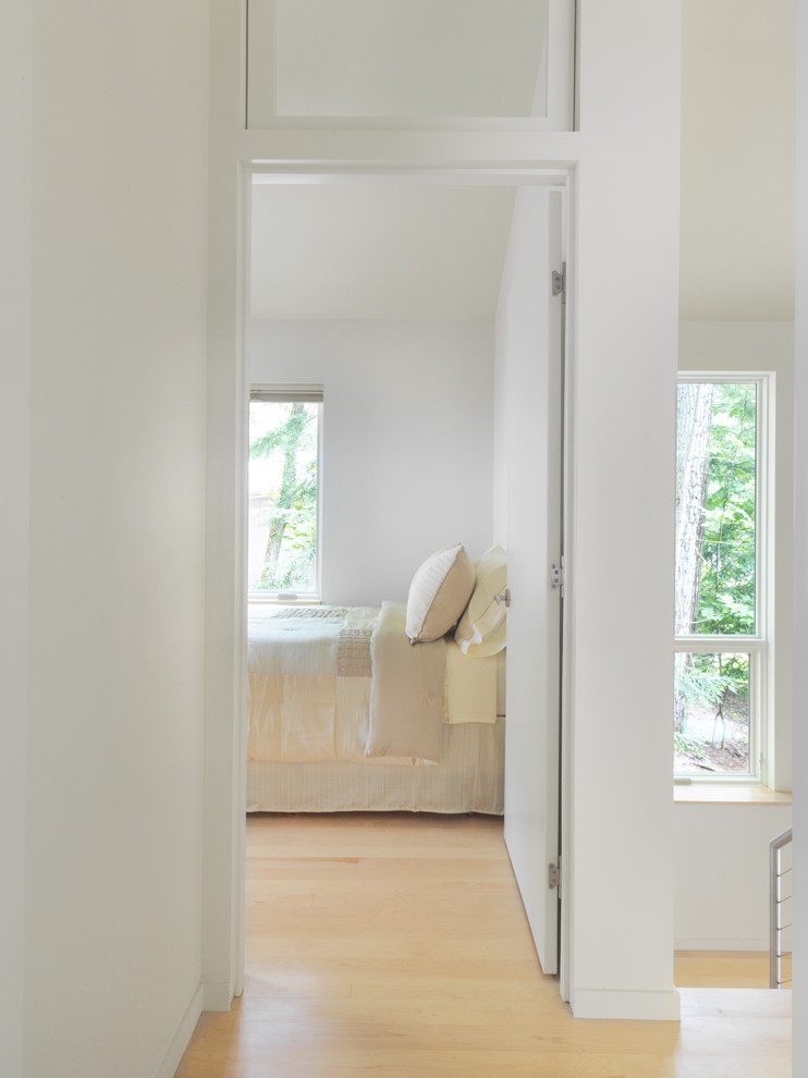 Photo of a contemporary bedroom in Burlington with white walls.