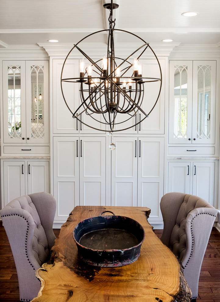 Inspiration for a traditional dining room in St Louis with dark hardwood floors and white walls.