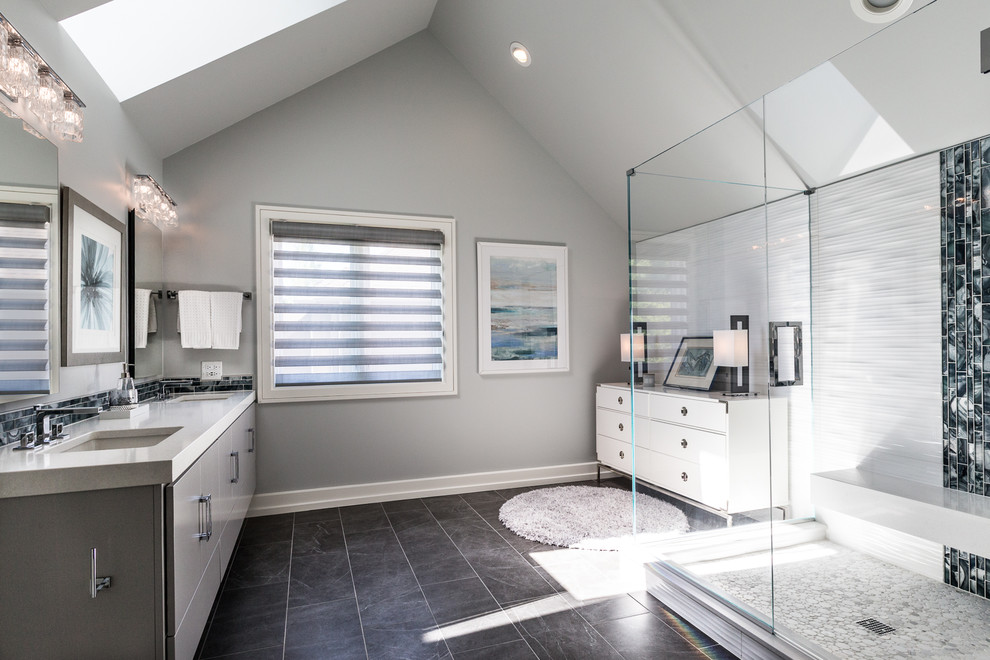 Large minimalist master white tile and porcelain tile porcelain tile and gray floor corner shower photo in Chicago with flat-panel cabinets, gray cabinets, a two-piece toilet, gray walls, an undermount sink, quartz countertops and a hinged shower door