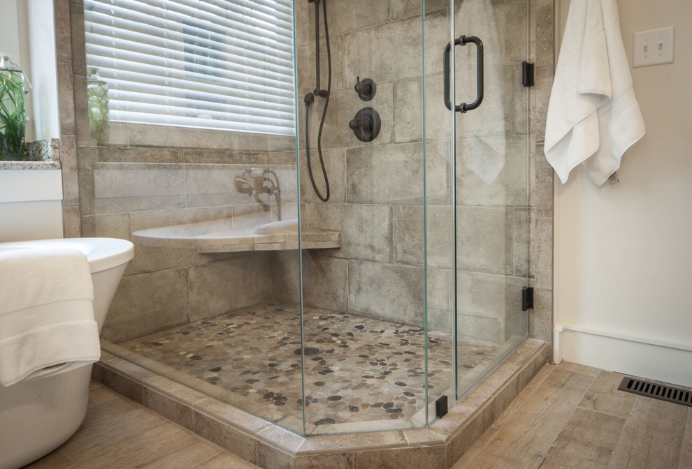Freestanding bathtub - mid-sized transitional master beige tile and stone tile ceramic tile and beige floor freestanding bathtub idea with raised-panel cabinets, gray cabinets, beige walls, an undermount sink, granite countertops and a hinged shower door