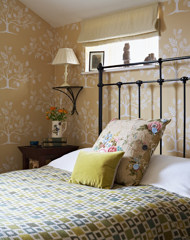 This is an example of a small traditional guest bedroom in Dorset with multi-coloured walls.