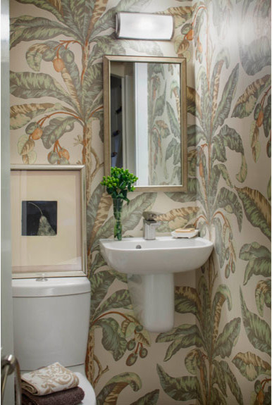 Photo of a small traditional powder room in Boston with a two-piece toilet, multi-coloured walls and a wall-mount sink.