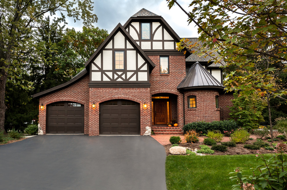 Inspiration for a mid-sized traditional two-storey brick red exterior in Detroit with a gable roof.