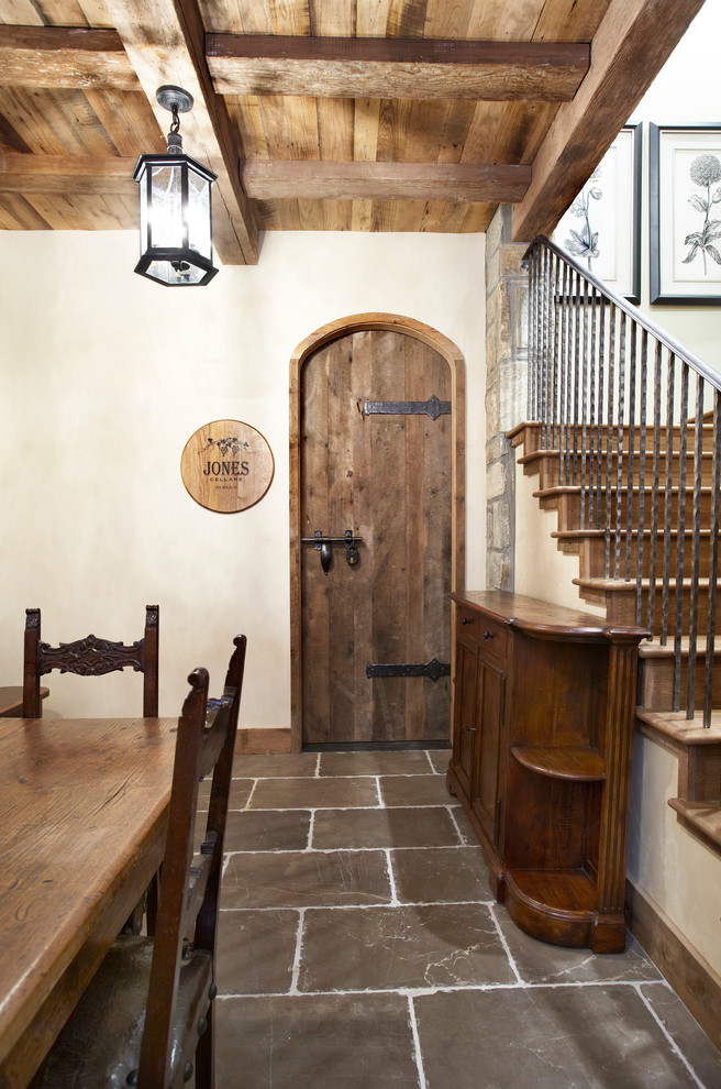 Design ideas for a mid-sized traditional wine cellar in Other with slate floors and storage racks.