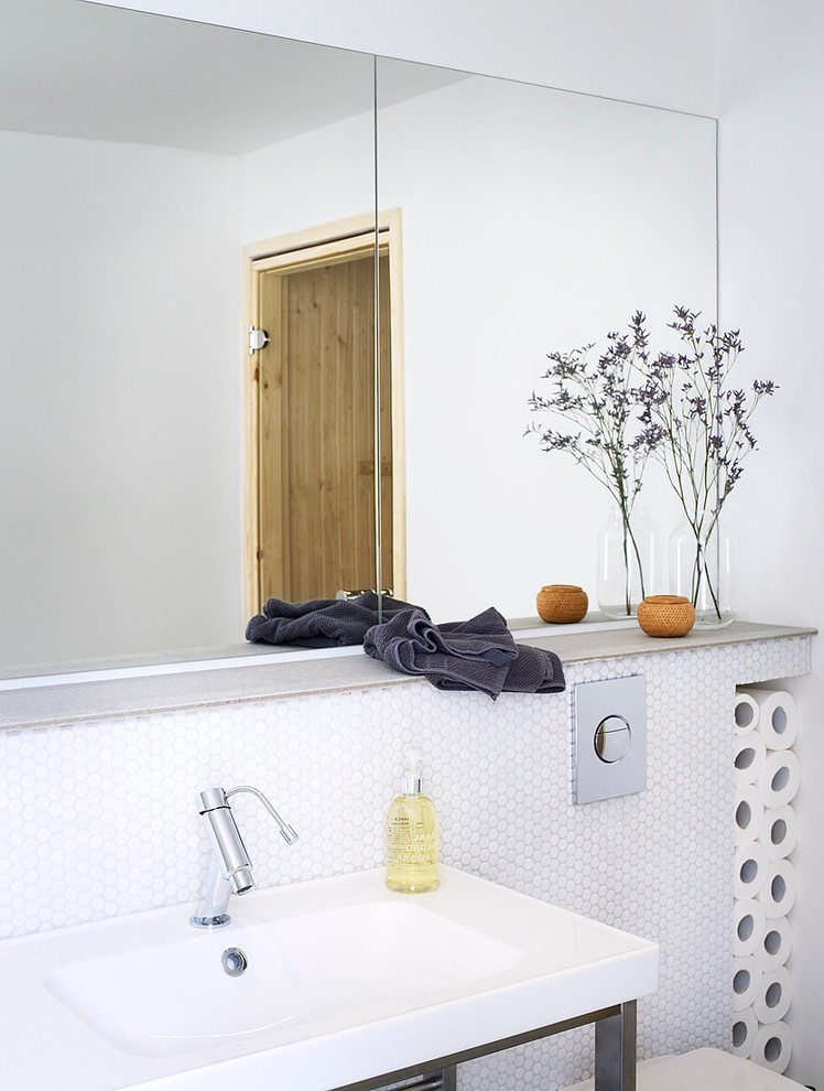 Photo of a scandinavian powder room in Stockholm with a console sink, white tile, white walls, open cabinets and mosaic tile.