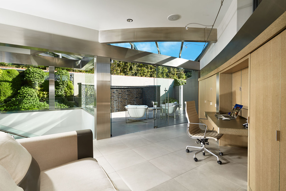 Contemporary study room in San Diego with a built-in desk and beige floor.