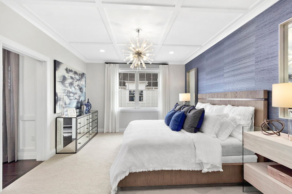 Transitional bedroom in New York with blue walls, carpet and beige floor.