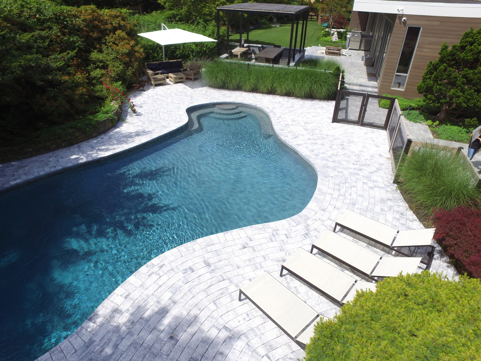 Pool - large backyard stone and custom-shaped aboveground pool idea in New York