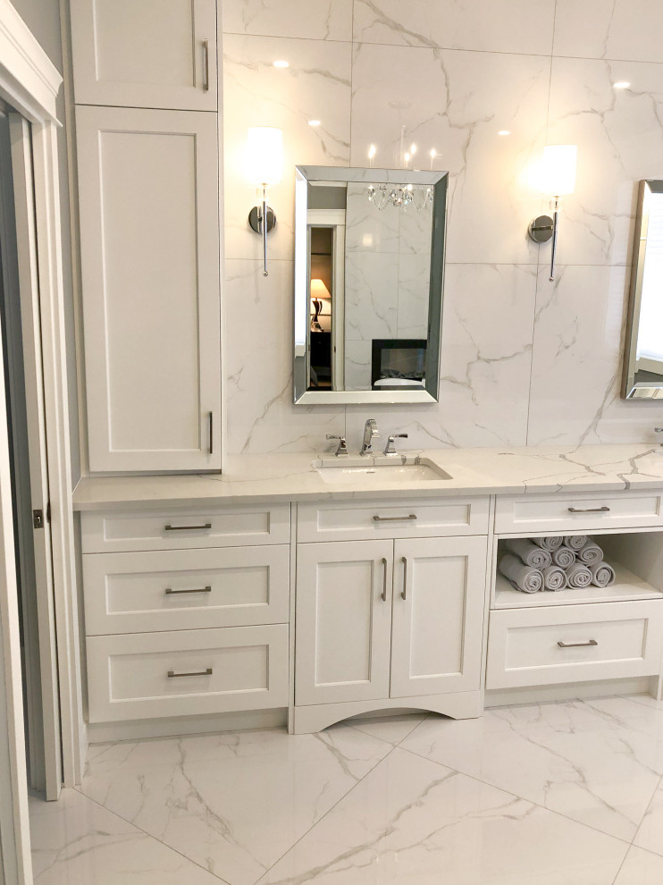 Photo of a large traditional master bathroom in Other with shaker cabinets, white cabinets, white tile, grey walls, porcelain floors, engineered quartz benchtops, white floor and white benchtops.