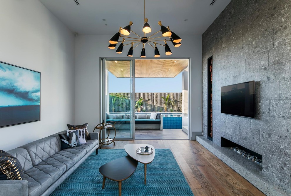 This is an example of a mid-sized contemporary formal open concept living room in Adelaide with grey walls, dark hardwood floors, a wall-mounted tv, a ribbon fireplace, a tile fireplace surround and brown floor.