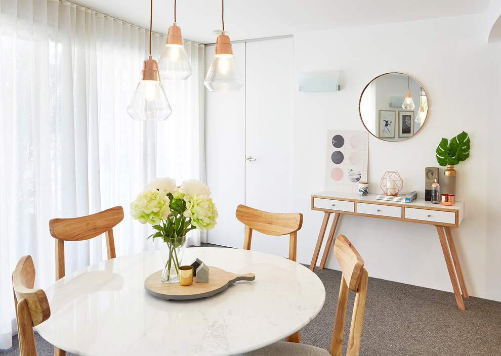 Photo of a scandinavian dining room in Sydney with white walls, carpet and no fireplace.