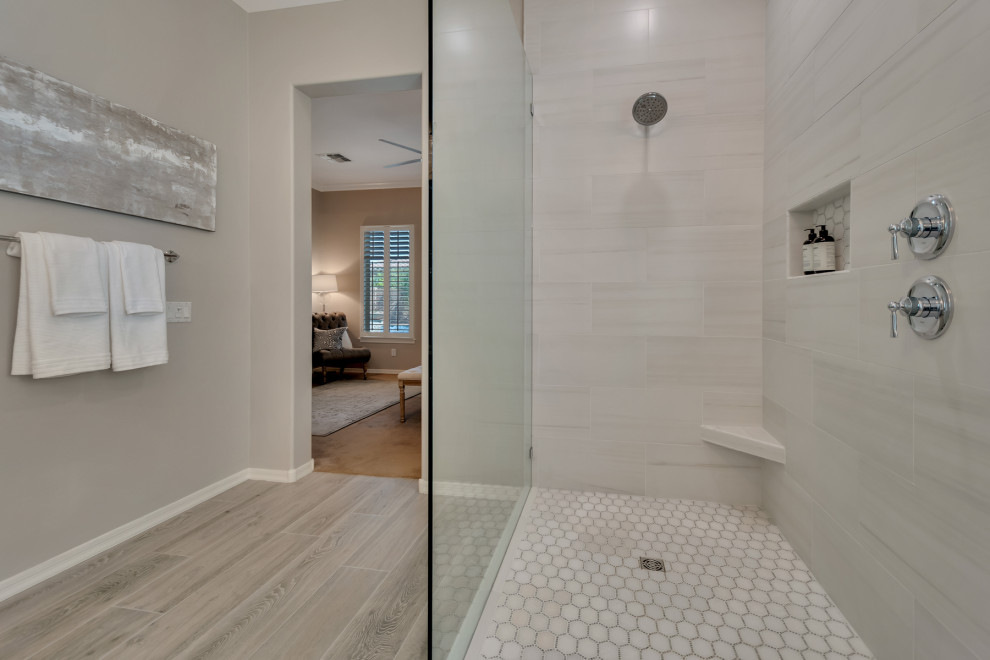 Mid-sized transitional master white tile and porcelain tile wood-look tile floor, multicolored floor and double-sink doorless shower photo in Phoenix with shaker cabinets, gray cabinets, gray walls, an undermount sink, granite countertops, white countertops and a niche