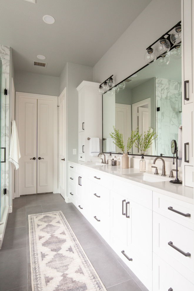 Design ideas for a large transitional master bathroom in Dallas with shaker cabinets, white cabinets, a freestanding tub, a corner shower, white tile, marble, grey walls, porcelain floors, an undermount sink, engineered quartz benchtops, grey floor, a hinged shower door, white benchtops, a double vanity and a built-in vanity.