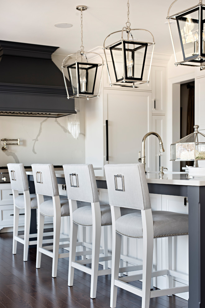 Large transitional l-shaped medium tone wood floor and brown floor open concept kitchen photo in Toronto with recessed-panel cabinets, white cabinets, white backsplash, an island, white countertops, an undermount sink, paneled appliances, quartz countertops and marble backsplash