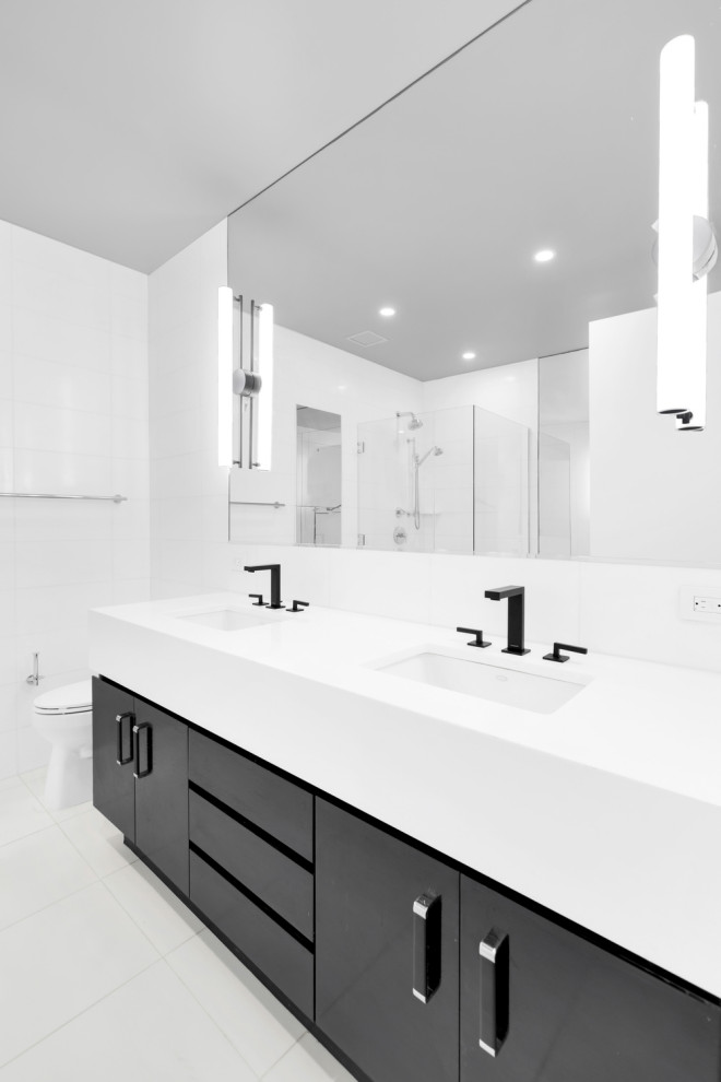 Свежая идея для дизайна: огромная главная ванная комната в стиле модернизм с открытым душем, унитазом-моноблоком, белой плиткой, мраморной плиткой, белыми стенами, полом из керамогранита, консольной раковиной, мраморной столешницей, белым полом, душем с распашными дверями, зеленой столешницей, тумбой под одну раковину, напольной тумбой и панелями на части стены - отличное фото интерьера