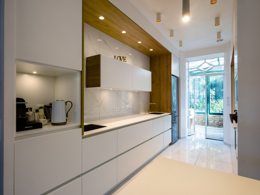 Idéer för ett mellanstort modernt vit kök med öppen planlösning, med en undermonterad diskho, vita skåp, marmorbänkskiva, vitt stänkskydd, stänkskydd i marmor, rostfria vitvaror, marmorgolv och vitt golv