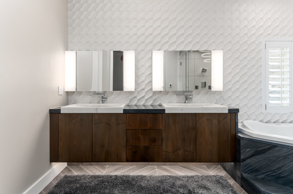 Photo of a large contemporary master bathroom in Salt Lake City with flat-panel cabinets, brown cabinets, a corner tub, a double shower, a one-piece toilet, white tile, porcelain tile, grey walls, wood-look tile, a vessel sink, granite benchtops, multi-coloured floor, a hinged shower door, a shower seat, a double vanity, a floating vanity and vaulted.