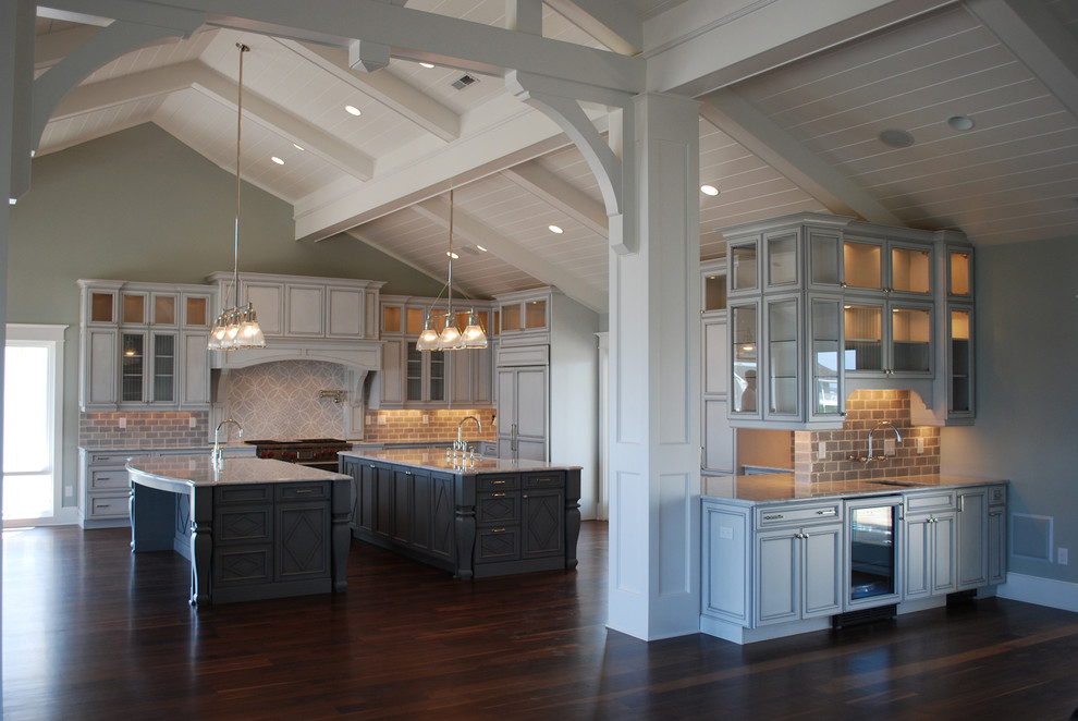 Inspiration for an expansive traditional u-shaped eat-in kitchen in Wilmington with a farmhouse sink, flat-panel cabinets, grey cabinets, stainless steel appliances, dark hardwood floors and multiple islands.