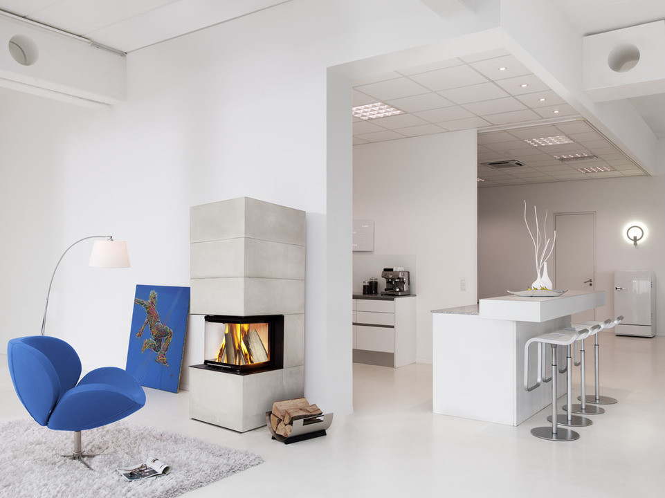 Photo of a small contemporary formal open concept living room in Cologne with grey walls, a corner fireplace and a concrete fireplace surround.