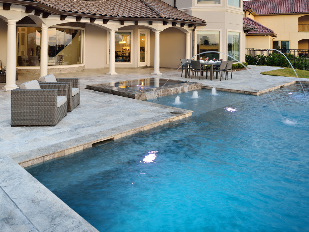 Large transitional backyard stone and custom-shaped infinity hot tub photo in Houston