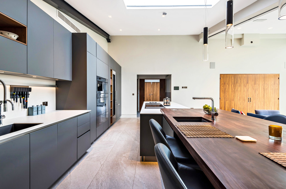 Design ideas for a contemporary galley open plan kitchen in Berkshire with flat-panel cabinets and with island.