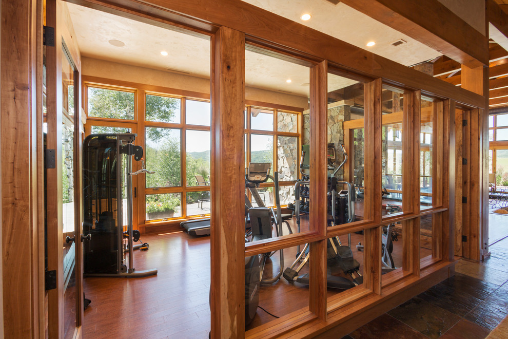 Design ideas for a mid-sized country home weight room in Denver with medium hardwood floors.