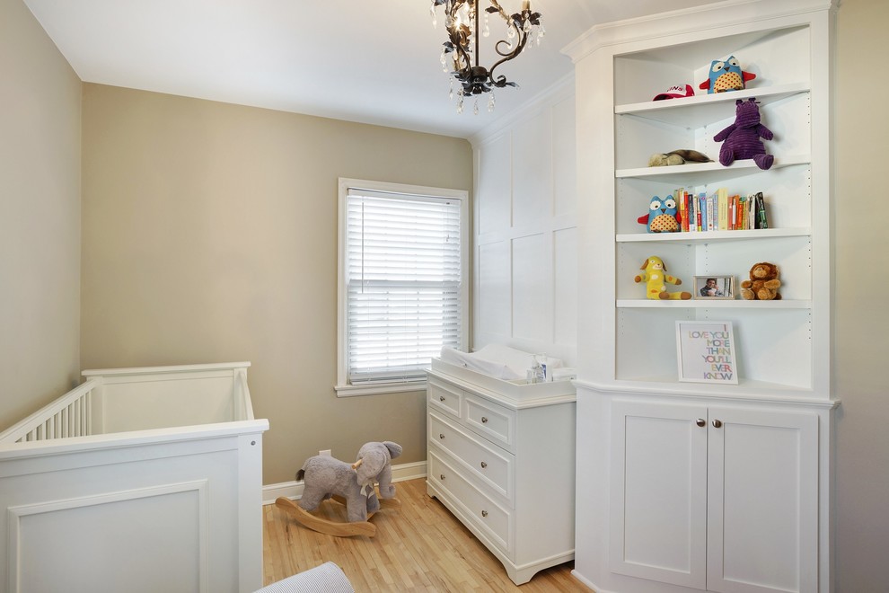 Mid-sized transitional gender-neutral nursery in Minneapolis with beige walls and light hardwood floors.
