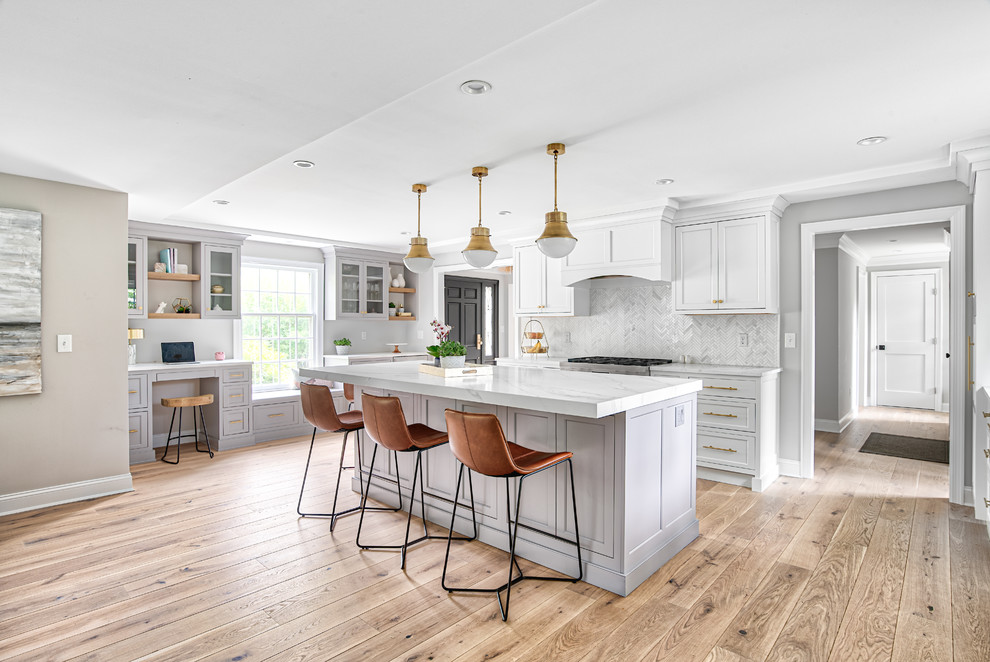 Large transitional u-shaped eat-in kitchen in New York with an undermount sink, beaded inset cabinets, white cabinets, quartz benchtops, white splashback, mosaic tile splashback, panelled appliances, with island and white benchtop.