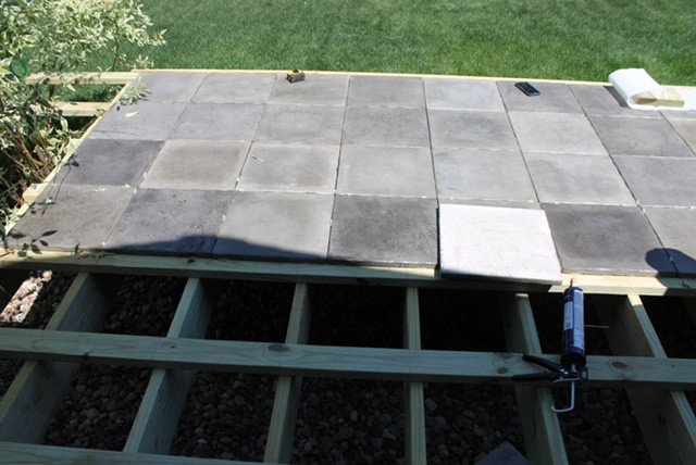 Small backyard ground level deck photo with no cover