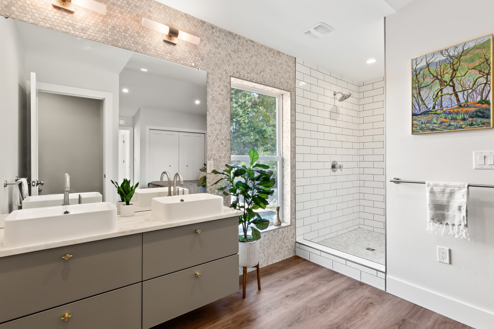 Mid-sized country bathroom in Tampa with furniture-like cabinets, grey cabinets, gray tile, marble, a vessel sink, marble benchtops, white benchtops, a niche, a double vanity and a floating vanity.