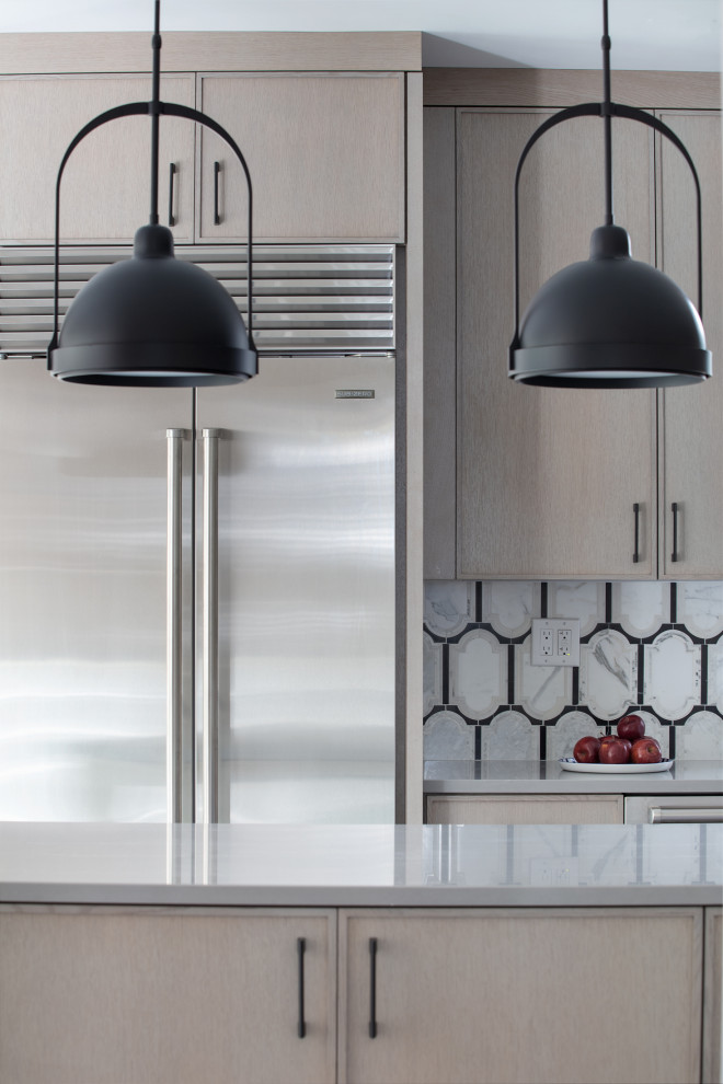 Example of a transitional kitchen design with an island
