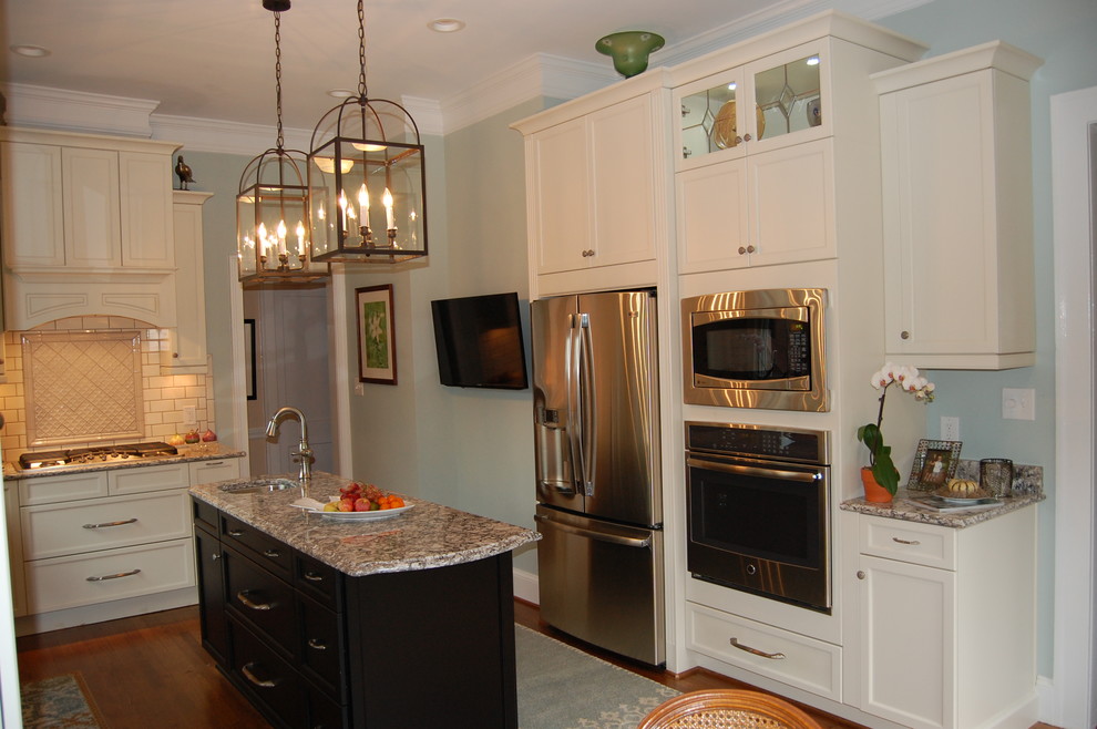 Eat-in kitchen - transitional u-shaped eat-in kitchen idea in Raleigh with an undermount sink, recessed-panel cabinets, white cabinets, quartzite countertops, white backsplash, subway tile backsplash and stainless steel appliances